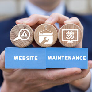 Man holding wooden blocks with the words website maintenance